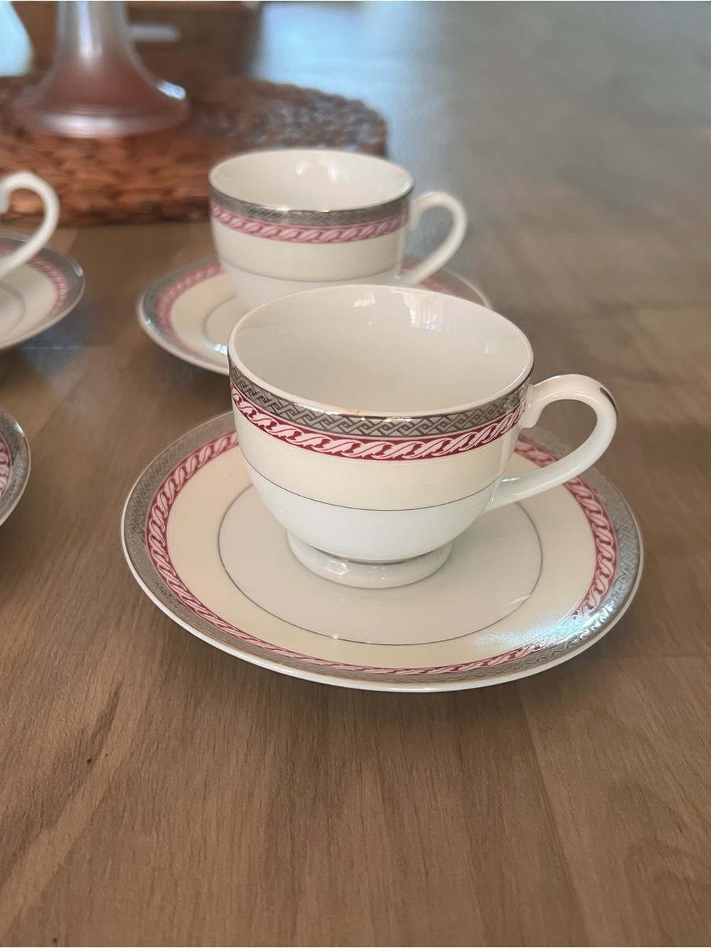 Elegant White Porcelain Teacup and Saucer Set with Pink and Silver Accents